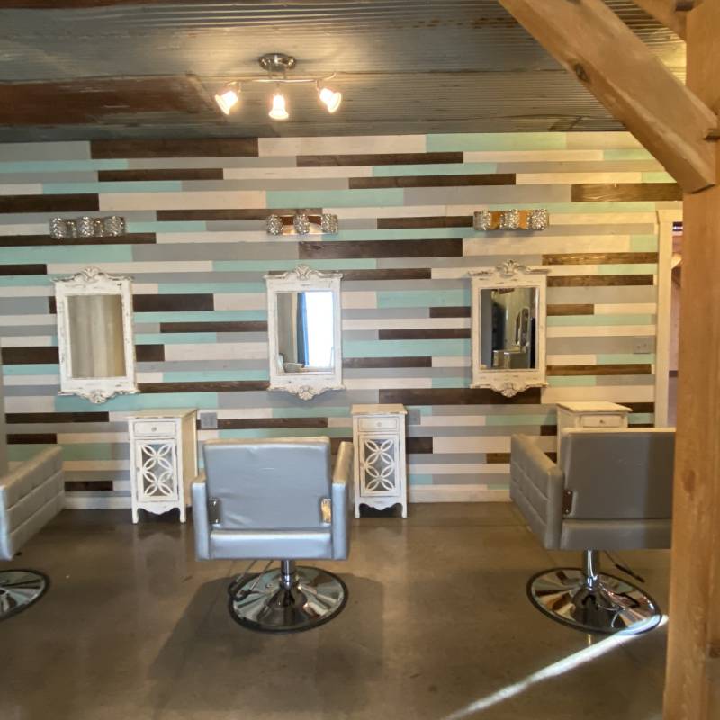 a salon with a wooden wall and chairs